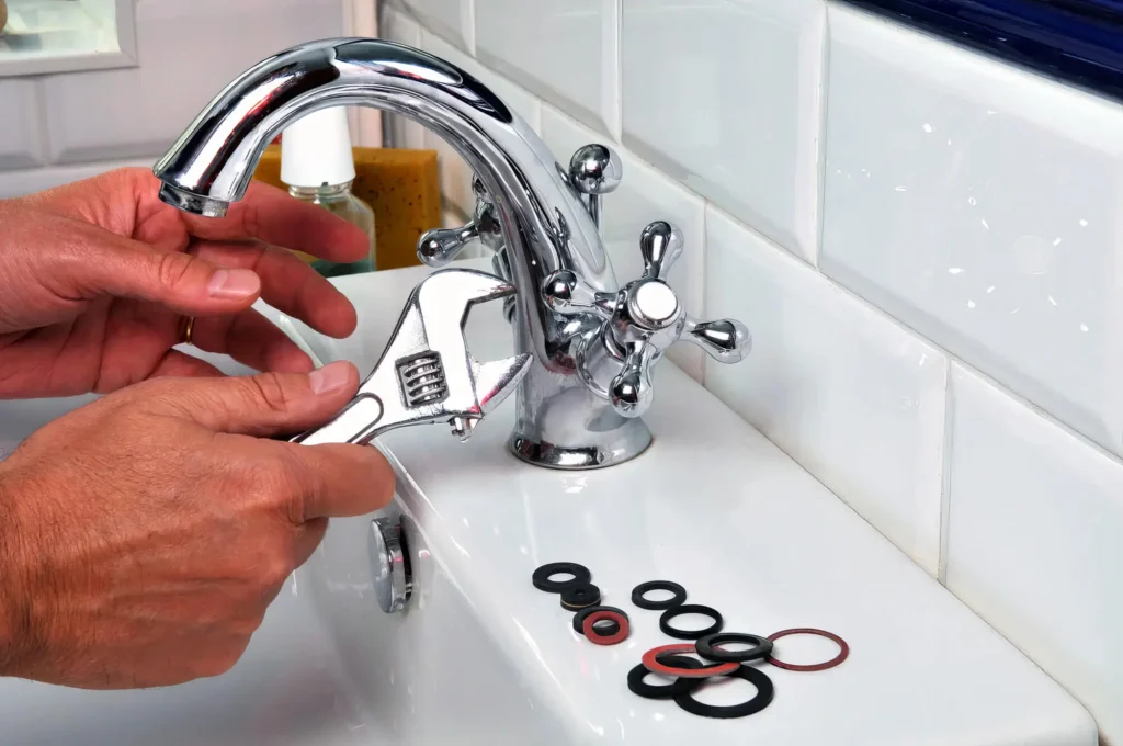 Plumber performing maintenance on a bathroom faucet in Warminster