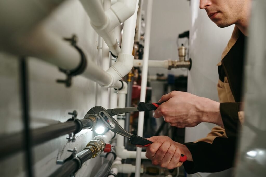 Plumbers maintaining commercial plumbing pipes in Warminster