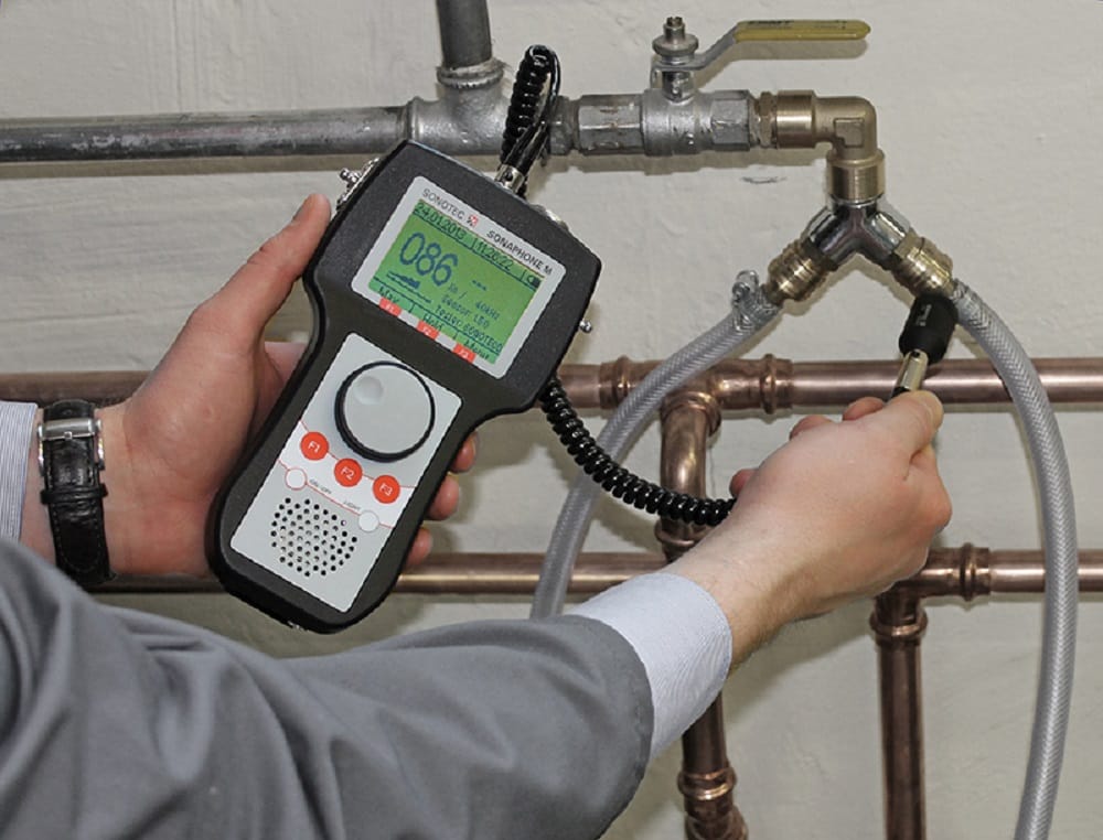 Plumber testing pipes with electronic leak detection equipment in Warminster