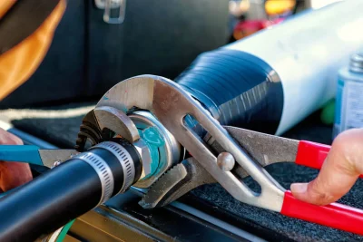 Technician tightening an industrial pipe connection in Warminster