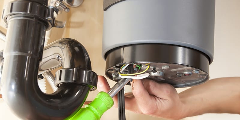 Technician repairing the heating element of a water heater in Warminster
