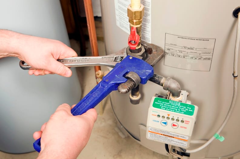 Plumber repairing a water heater valve in Warminster
